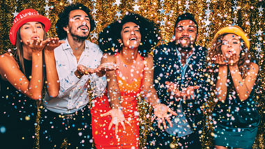 nye confetti falling on celebrators