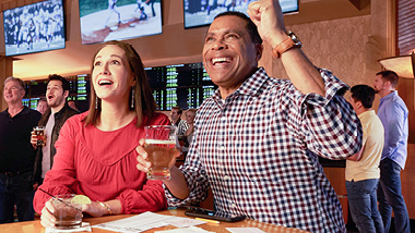 People cheering and betting at the sportsbook