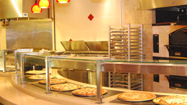 pizzas behind a shield