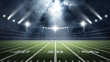 football stadium at night with dark clouds and lights